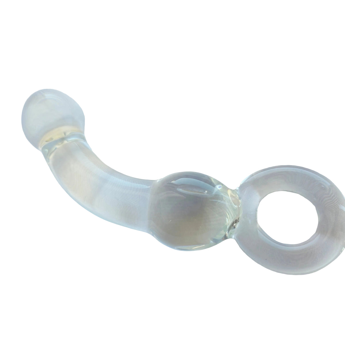 A clear glass curved wand with a ring handle, resting on a white fabric surface.