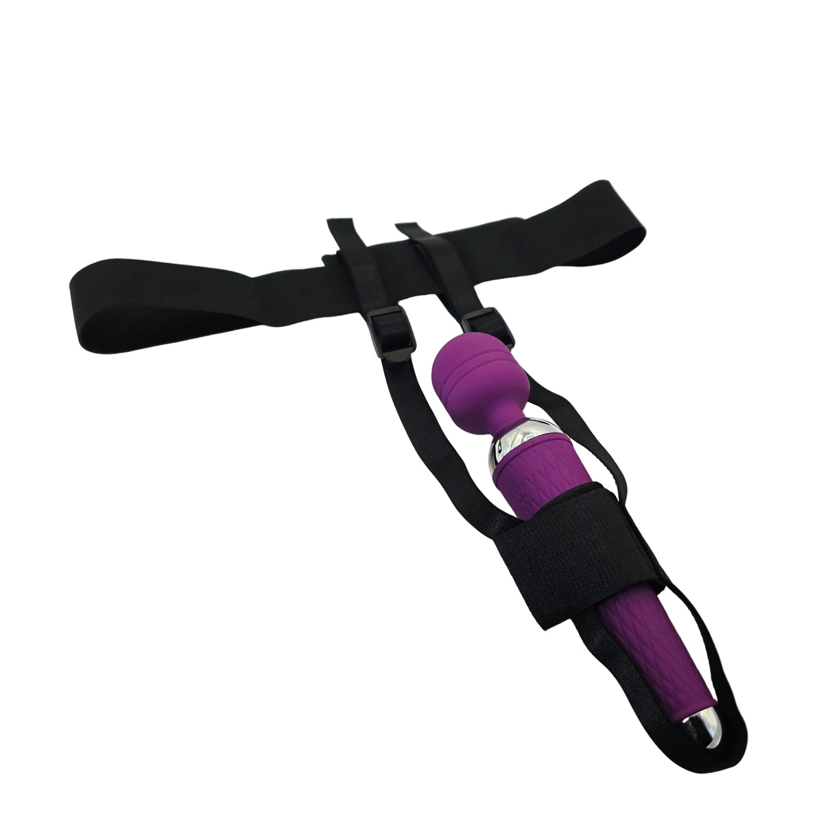 A purple handheld wand massager with a black elastic strap harness, resting on a white satin fabric surface.
