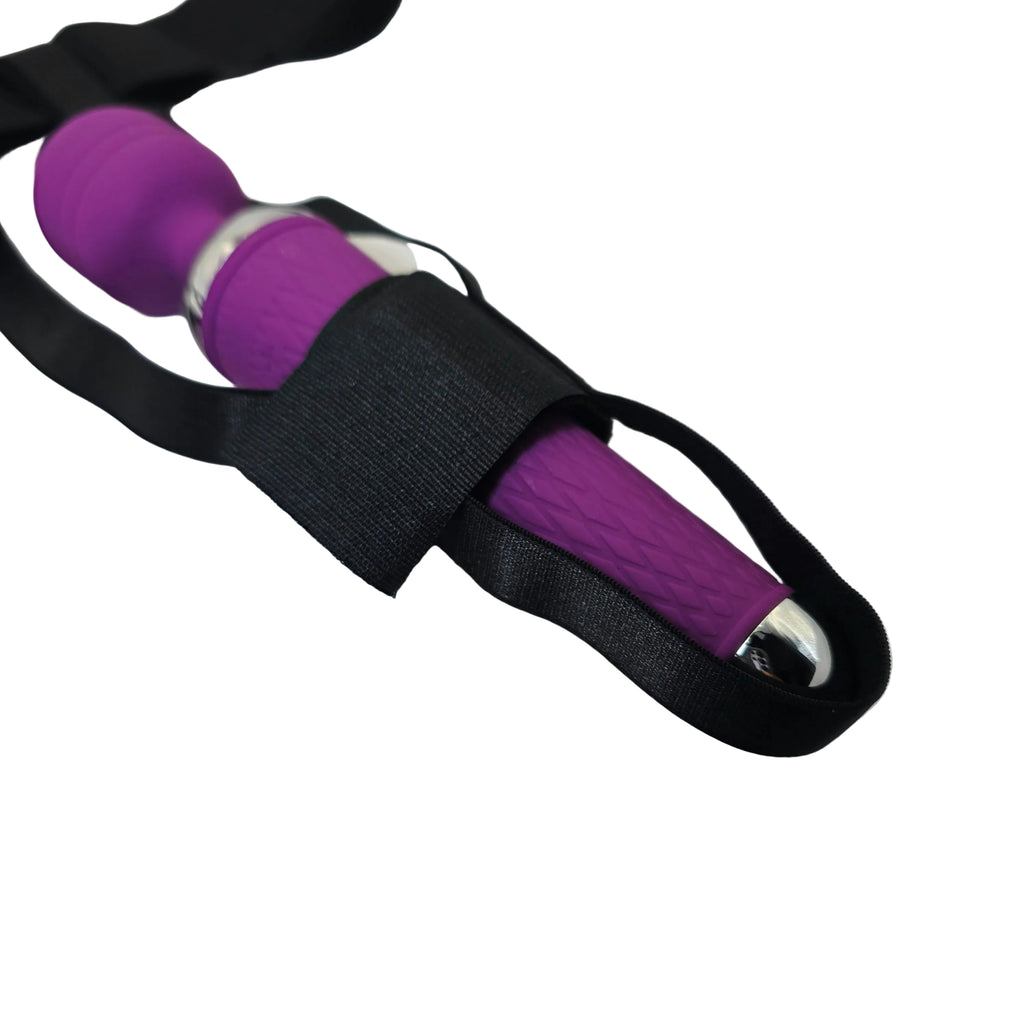 A close-up of a purple textured wand massager wrapped in a black elastic strap, resting on a white satin fabric background.