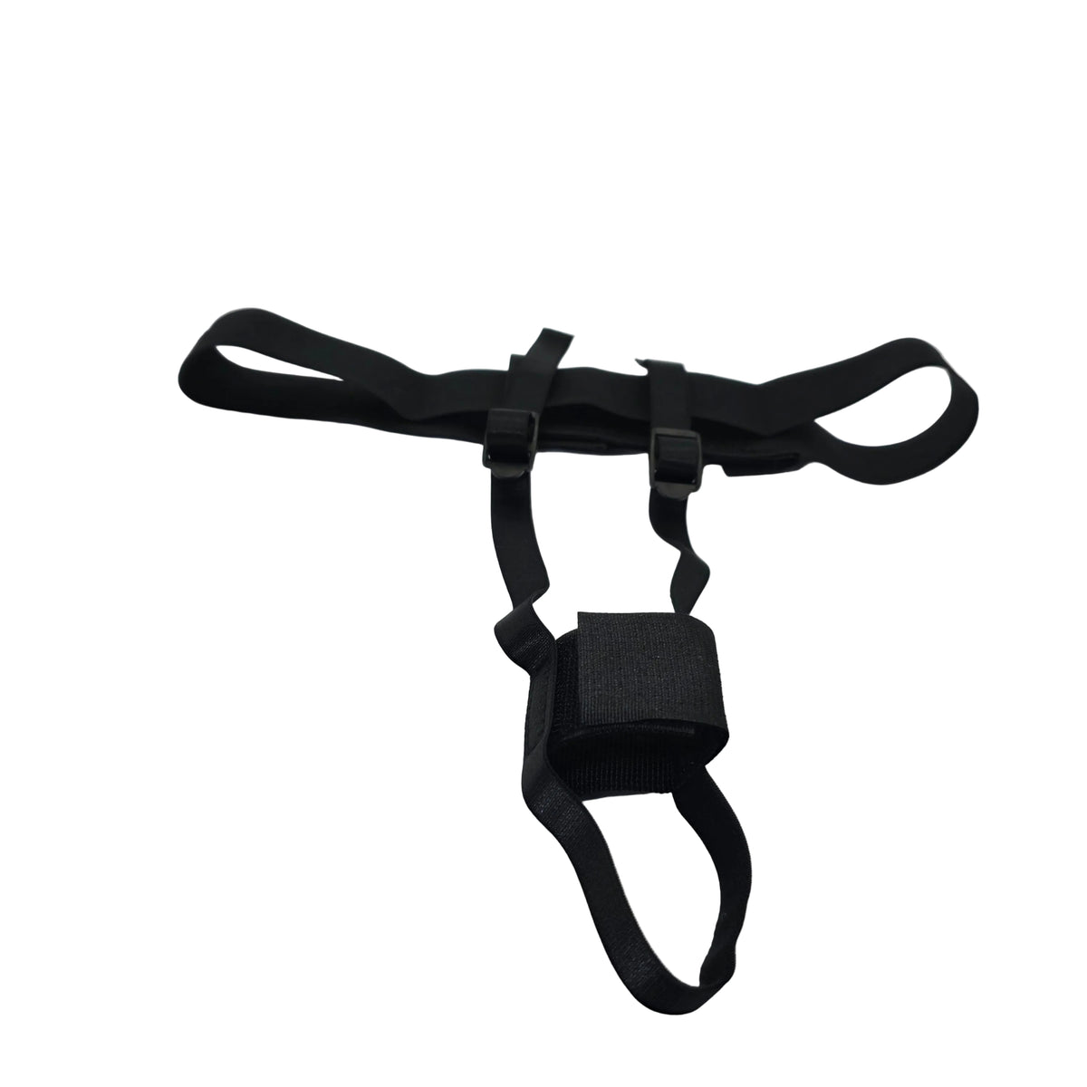 A black adjustable harness-style strap accessory with plastic buckles and a central loop, laid on a white satin-like fabric surface.