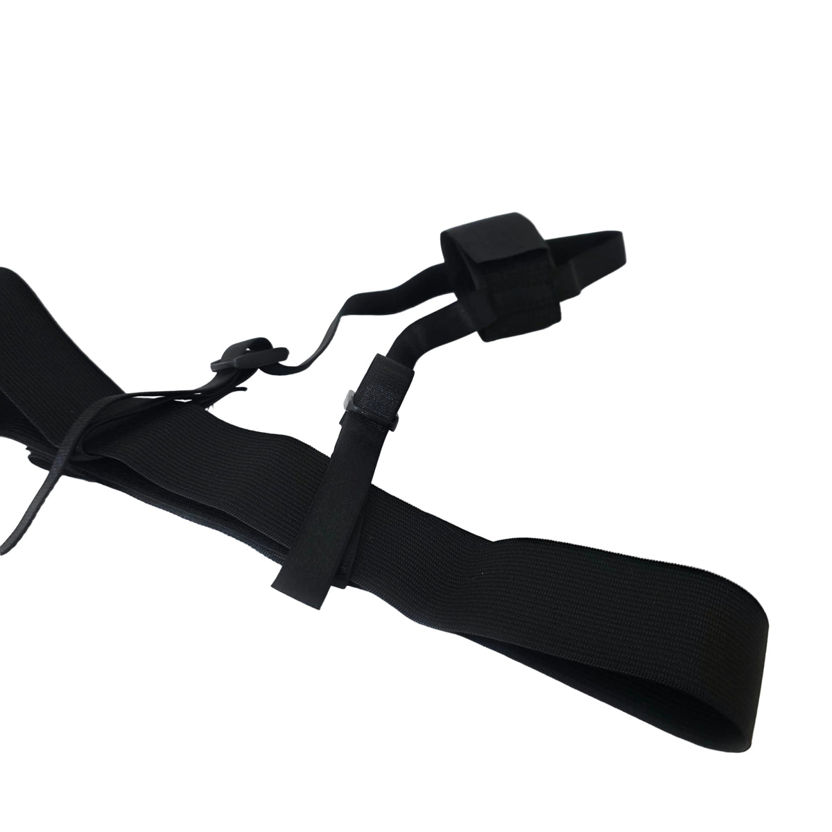 A black adjustable elastic strap with plastic buckle closures, laid out on a white satin-like fabric surface.
