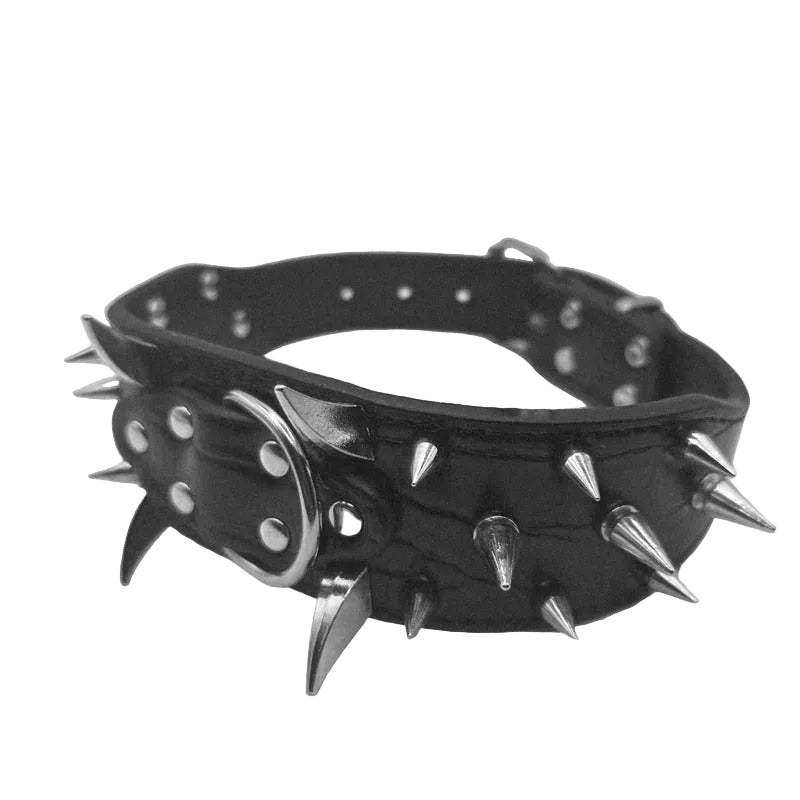 A black leather spiked collar with silver metal spikes and studs, photographed on a neutral light gray background.