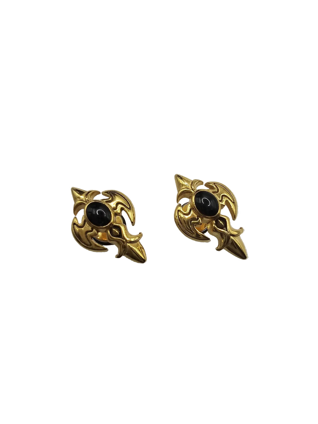A pair of vintage-style gold-toned earrings with a central black oval stone, displayed on a textured light gray fabric background.